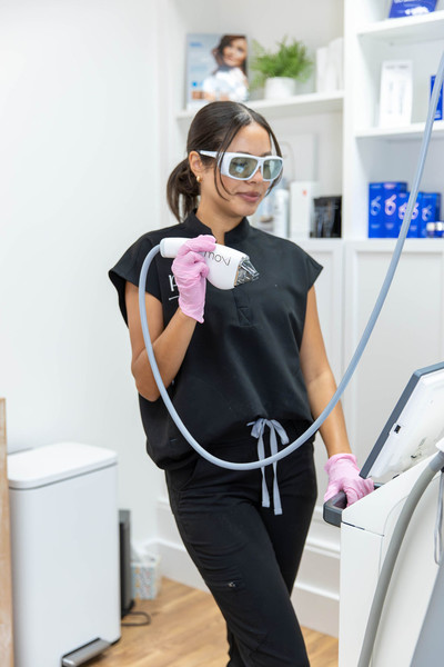 Registered nurse holding a Moxi laser handpiece at a Franklin, TN skincare clinic